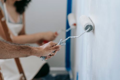 Adding a fresh coat of paint to a wall